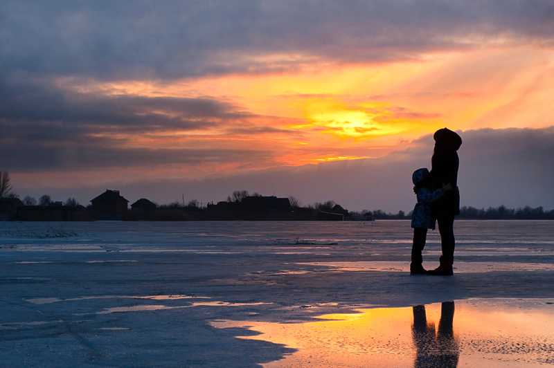 mother holding child on beach